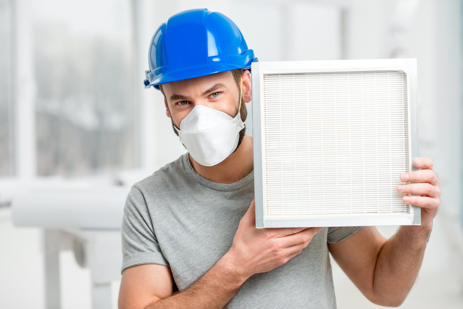worker-holding-air-filter-installing-house-ventilation-system-purity-air-concept
